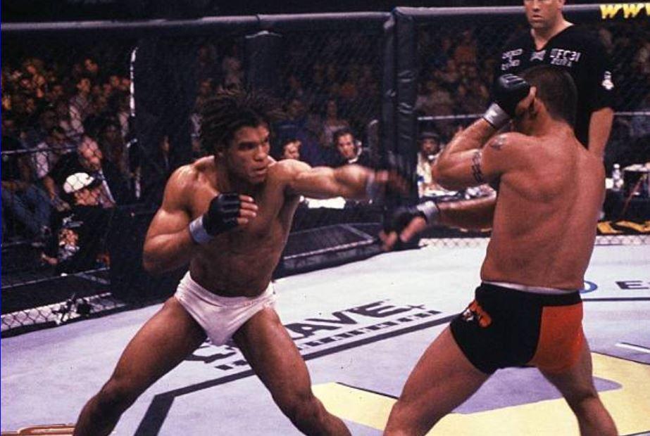 Carlos Newton throwing a jab against Pat Miletich. Credits to: Susumu Nagao - Getty Images.
