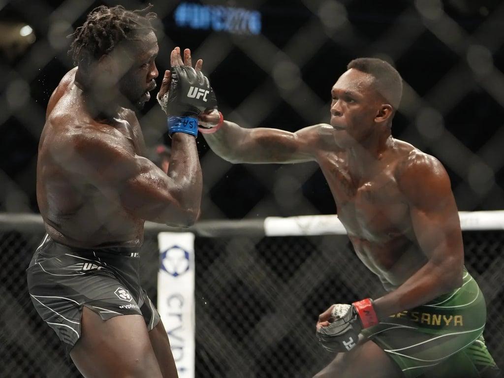 Israel Adesanya landing on Jared Cannonier in the main event clash at UFC 276. Credits to: Stephen R. Sylvanie - USA TODAY Sports.