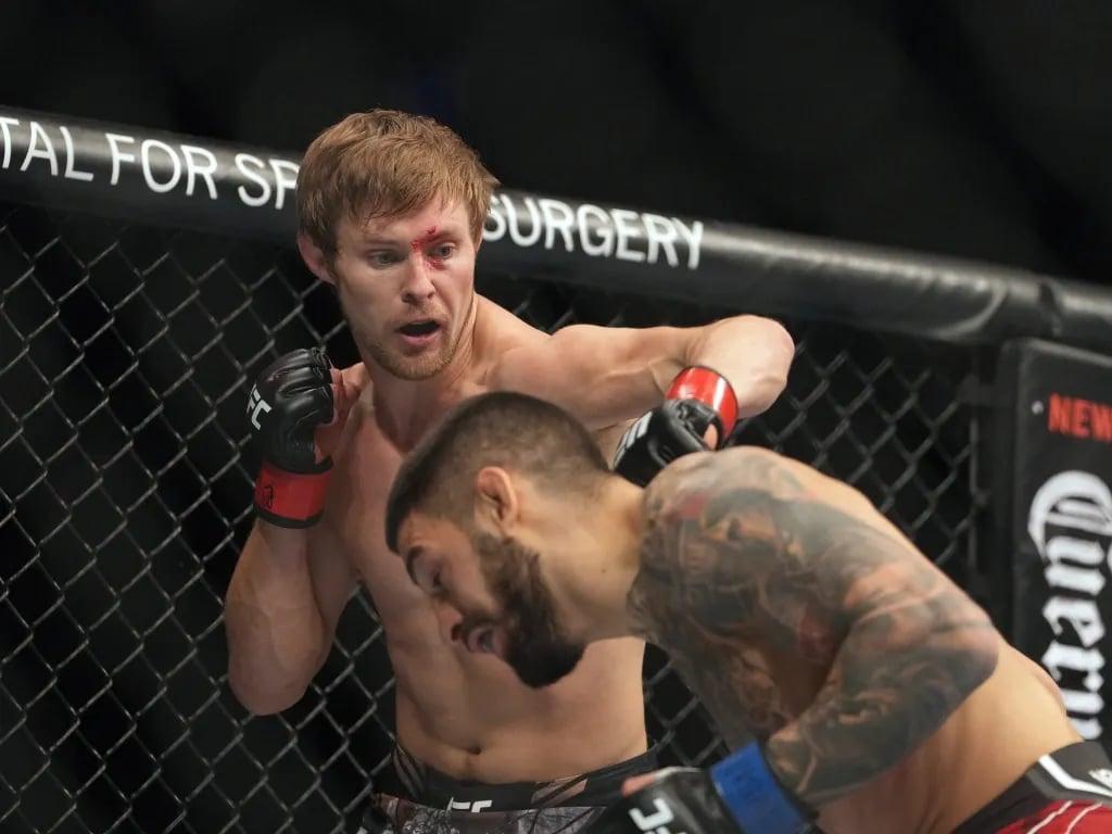 Bryce Mitchell battling against Ilia Topuria at UFC 282. Credits to: Stephen R. Sylvanie - USA TODAY Sports.