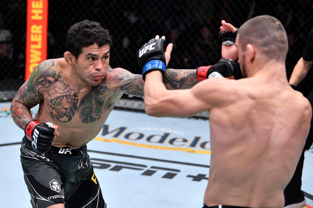 Diego Ferreira unloads a right hand on Mateusz Gamrot. Credit: MMA Fighting.