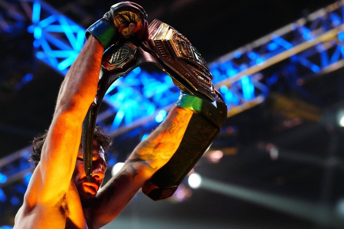 Alexandre Pantoja lifting his Flyweight title at UFC 290. Credits to: Stephen R. Sylvanie - USA TODAY Sports.