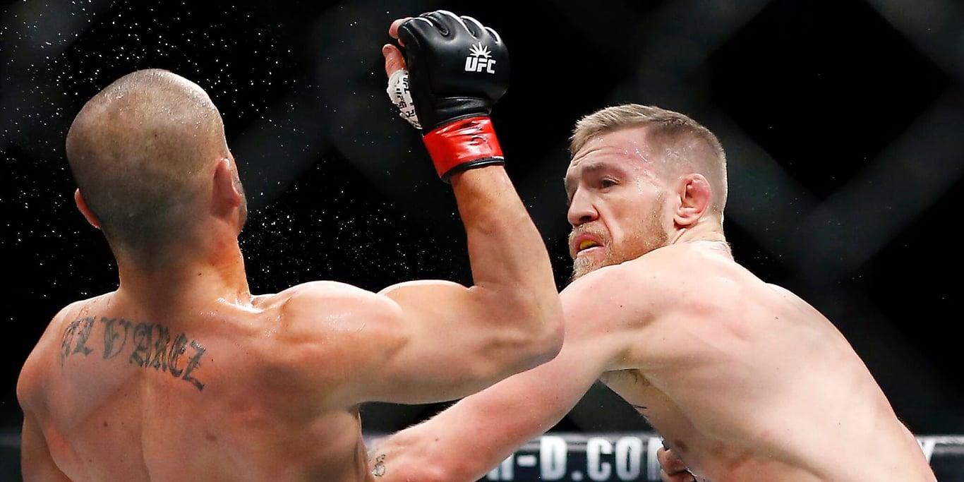 Conor McGregor sparking Eddie Alvarez in his UFC Lightweight debut. Credits to: Adam Hunger - USA TODAY Sports.