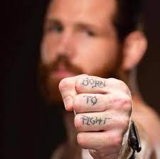 Clay Collard's Hand tattoo that reads 'Born To Fight'.