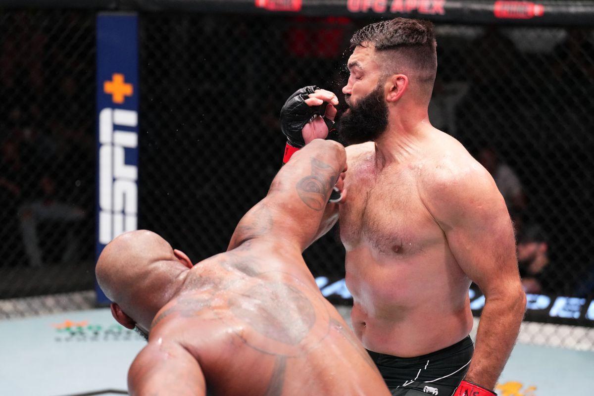 Don'Tale Mayes lands an overhand on Andrei Arlovski. Credit: MMA Fighting.