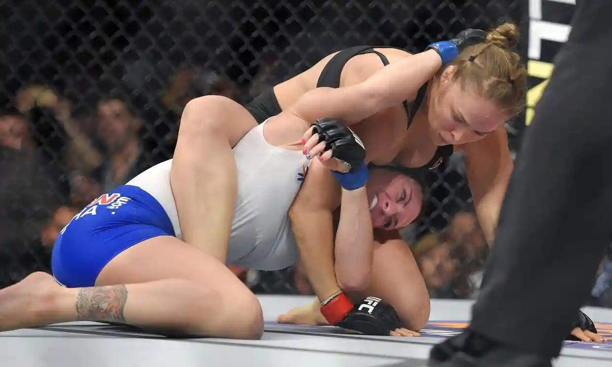 Ronda Rousey showcasing her signature armbar. Credit: Mark J. Terrill/AP